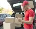 medium-shot-delivery-guy-with-phone